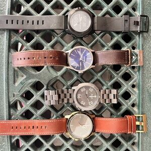 4 Nixon watches. In good condition. 
All but the digital need new batteries.